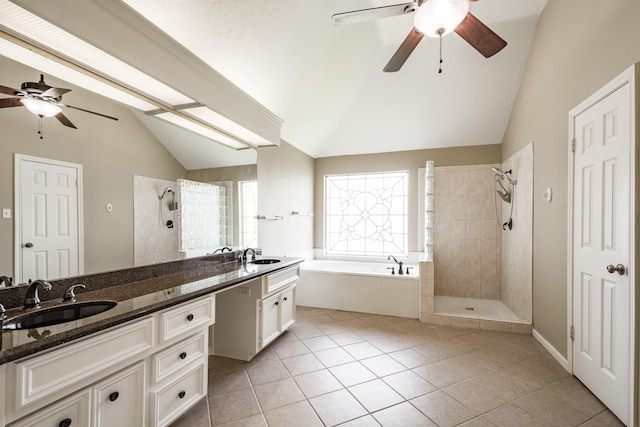 bathroom featuring vaulted ceiling, walk in shower, a bath, and vanity