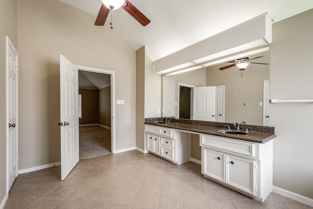 full bathroom with lofted ceiling, tile patterned flooring, double vanity, and a sink