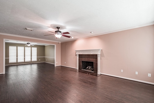 unfurnished living room with a tile fireplace, wood finished floors, visible vents, and crown molding