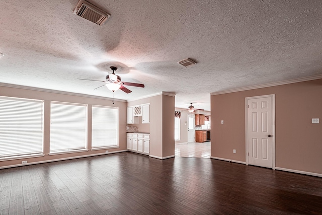 unfurnished living room with ornamental molding, dark wood-style flooring, visible vents, and a ceiling fan