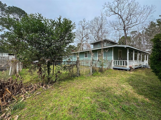 view of yard with a porch and fence