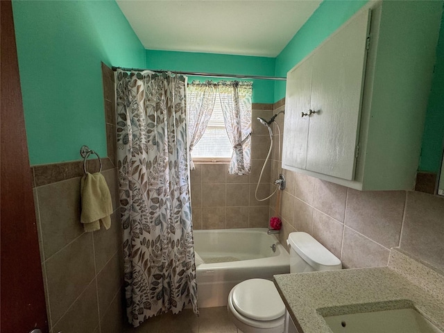 bathroom with shower / bathtub combination with curtain, tile walls, toilet, and vanity