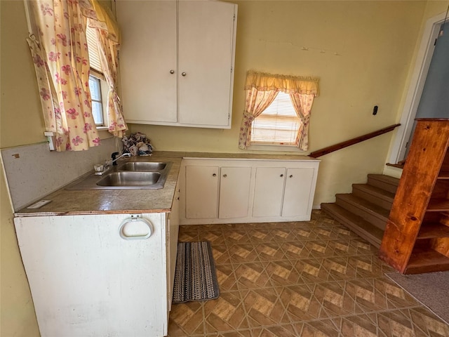 kitchen with a sink and white cabinets