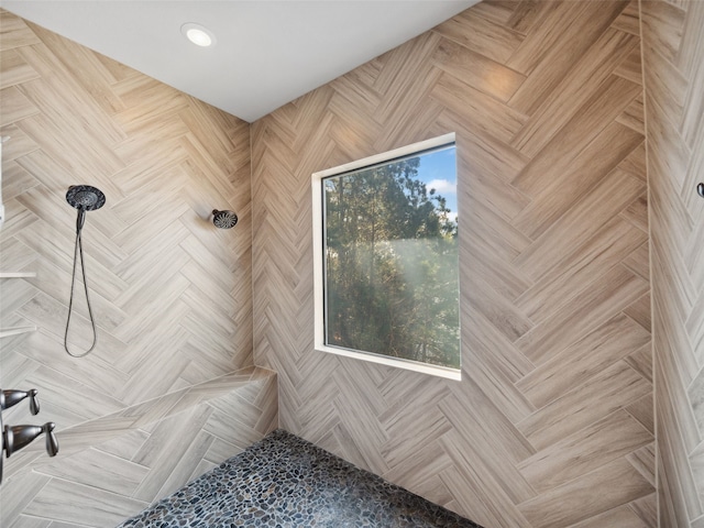 full bathroom with a tile shower and recessed lighting