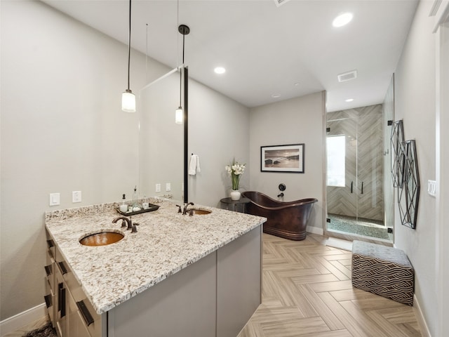 bathroom with a freestanding tub, a sink, visible vents, double vanity, and a stall shower