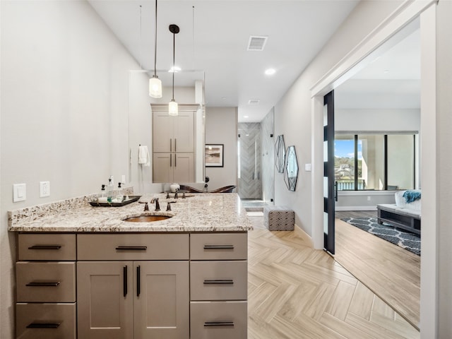 full bath featuring a stall shower, baseboards, visible vents, vanity, and recessed lighting