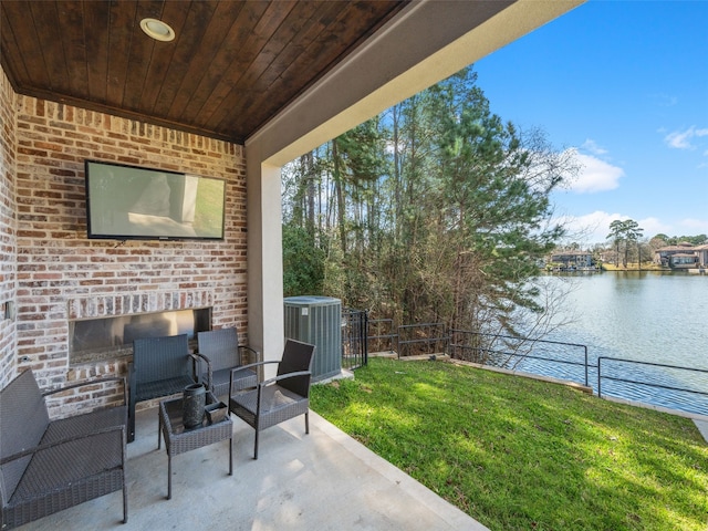 view of patio / terrace with a water view, fence, and central AC