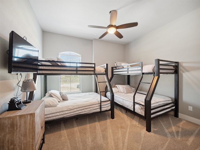 carpeted bedroom featuring ceiling fan and baseboards