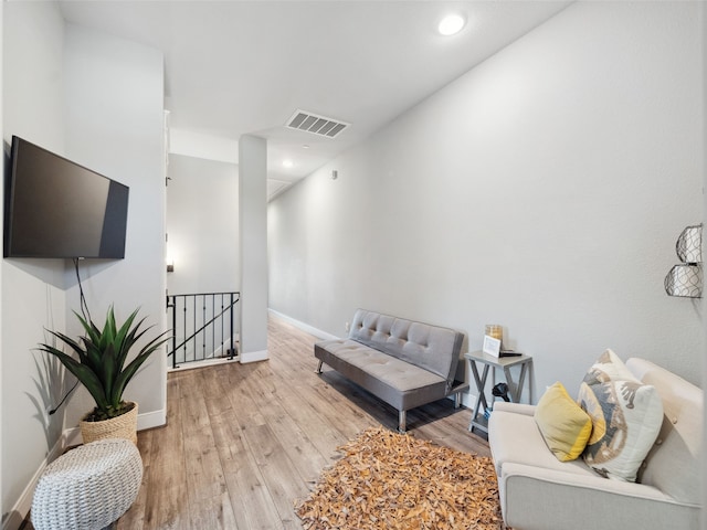 sitting room featuring recessed lighting, visible vents, an upstairs landing, wood finished floors, and baseboards