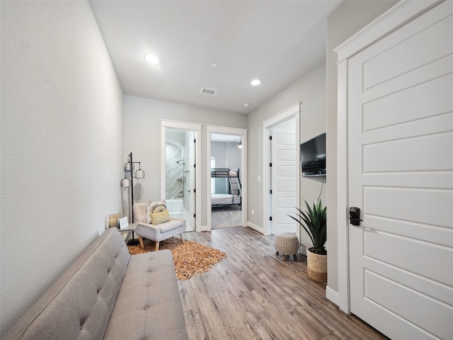 interior space with baseboards, visible vents, wood finished floors, and recessed lighting