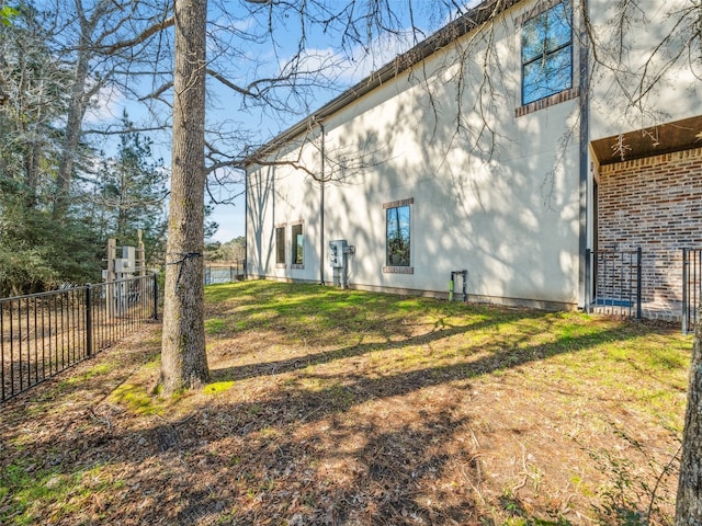 back of property with fence and a yard