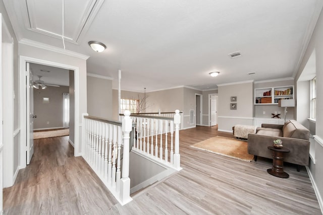 corridor featuring attic access, visible vents, an upstairs landing, and wood finished floors