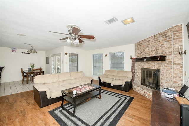 3003 Pierre Pl, College Station, TX 77845 - living room featuring a ceiling fan, light wood-style flooring, and a brick fireplace