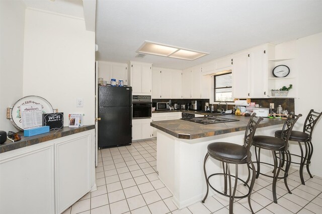 3003 Pierre Pl, College Station, TX 77845 - kitchen with black appliances, dark countertops, a peninsula, open shelves, and light tile patterned flooring