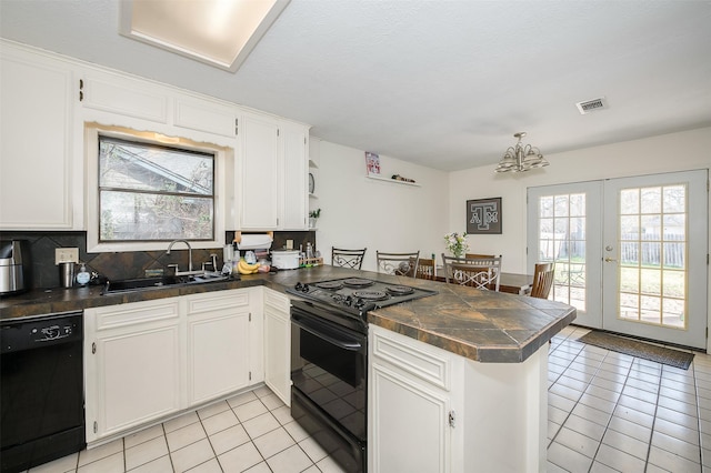 3003 Pierre Pl, College Station, TX 77845 - kitchen with black appliances, a peninsula, dark countertops, light tile patterned floors, and plenty of natural light