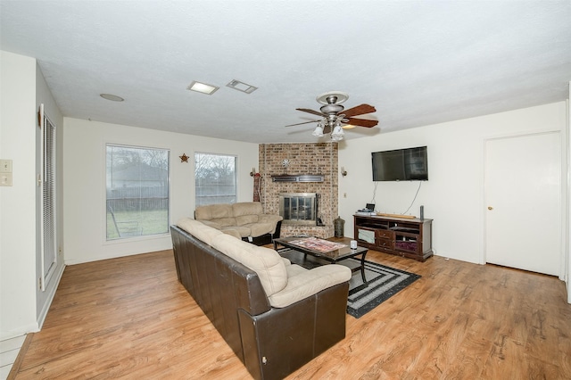 3003 Pierre Pl, College Station, TX 77845 - living area with light wood-type flooring, a fireplace, and a ceiling fan