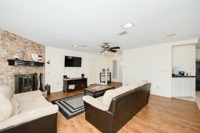 3003 Pierre Pl, College Station, TX 77845 - living area featuring light wood finished floors, ceiling fan, and a fireplace