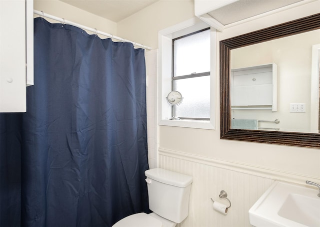 3003 Pierre Pl, College Station, TX 77845 - bathroom with a wainscoted wall, curtained shower, and a decorative wall