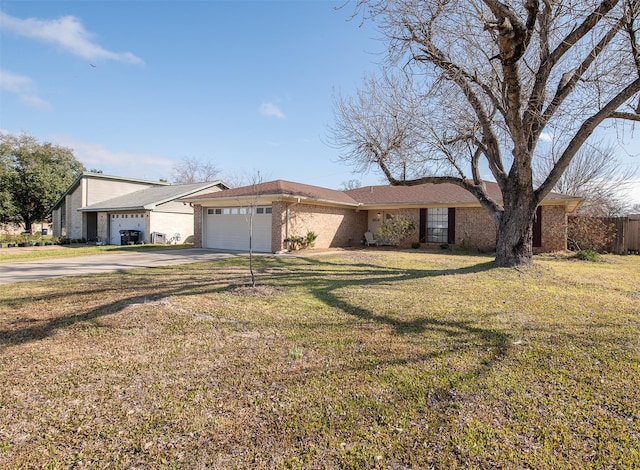 3003 Pierre Pl, College Station, TX 77845 - view of front of home with a garage, concrete driveway, a front yard, and brick siding