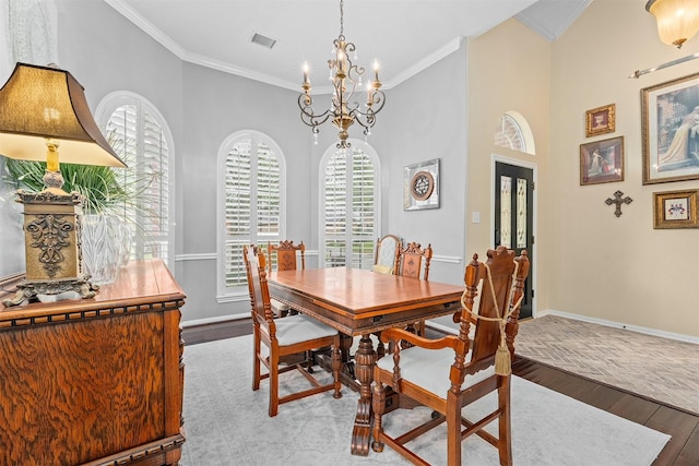 dining area with ornamental molding, visible vents, baseboards, and wood finished floors