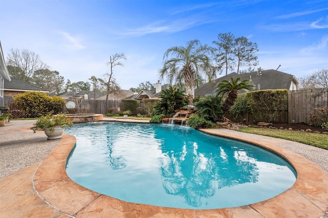 view of pool featuring a fenced backyard and a pool with connected hot tub