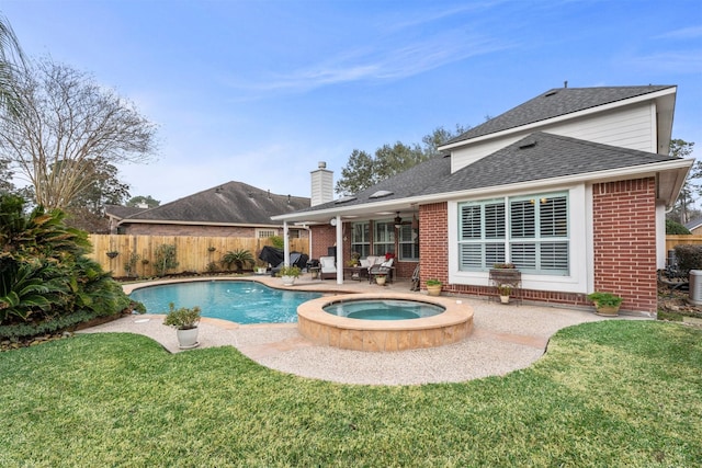 back of house featuring a patio, a fenced backyard, brick siding, a ceiling fan, and a yard