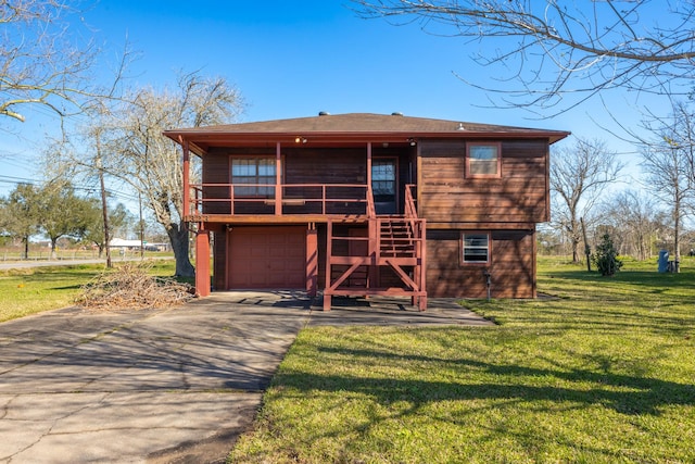 view of front of home featuring an attached garage, driveway, a front lawn, and stairs