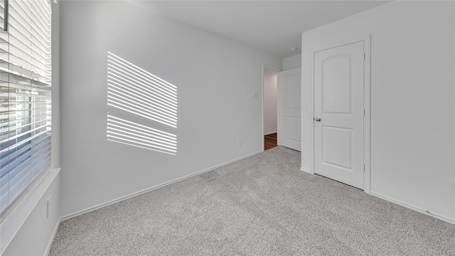 unfurnished bedroom with carpet and baseboards