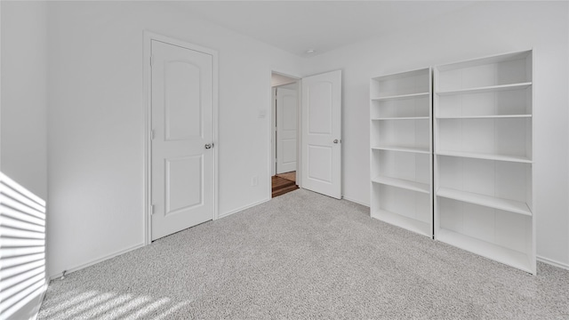 unfurnished bedroom featuring carpet flooring and baseboards