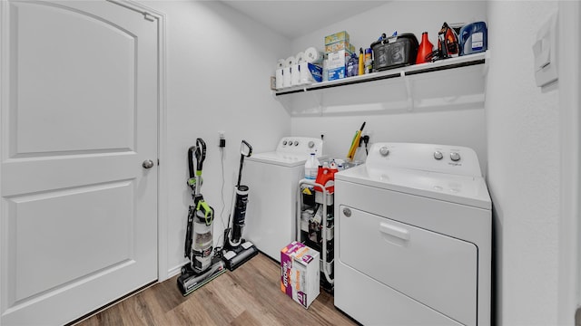 laundry room featuring light wood-type flooring, laundry area, and independent washer and dryer