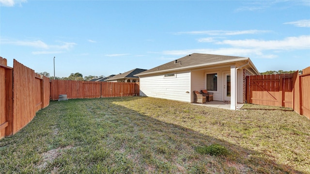 back of house with a lawn, a patio area, and a fenced backyard