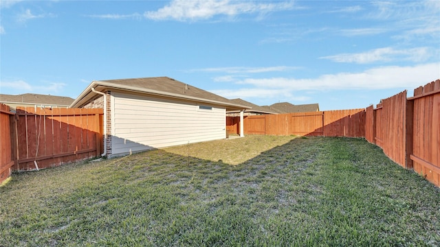 view of yard with a fenced backyard