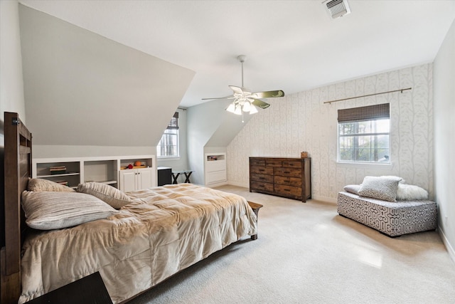 bedroom featuring carpet, visible vents, baseboards, and wallpapered walls