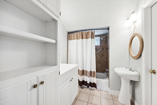 full bathroom featuring a sink, shower / tub combo with curtain, baseboards, and tile patterned floors