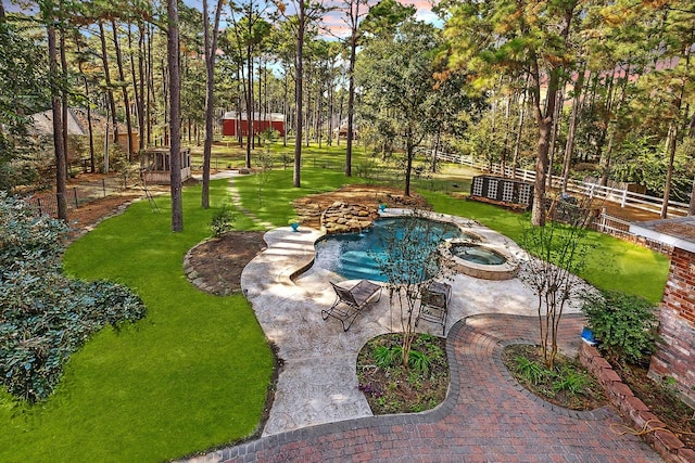 view of pool with a pool with connected hot tub, a patio, and a yard