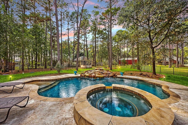 view of pool featuring a yard, a patio, a fenced backyard, and a pool with connected hot tub