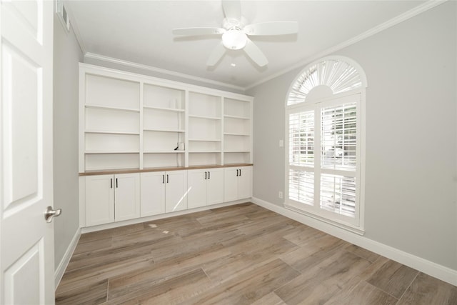 unfurnished room featuring a ceiling fan, baseboards, visible vents, light wood finished floors, and crown molding