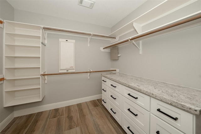 walk in closet with dark wood-style floors and visible vents