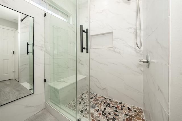 full bath with a marble finish shower