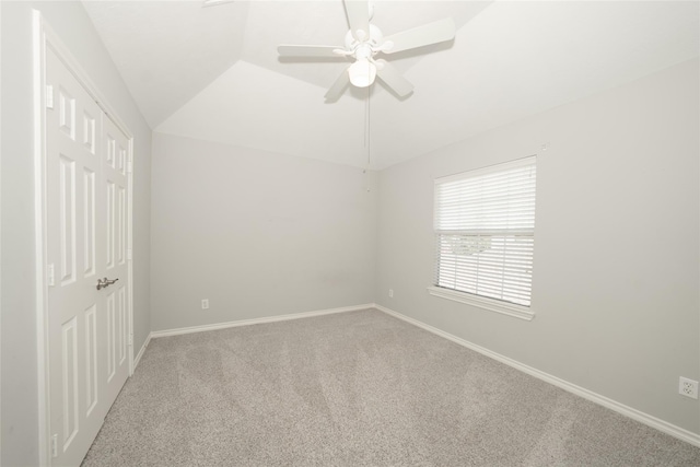 unfurnished room featuring vaulted ceiling, ceiling fan, carpet flooring, and baseboards