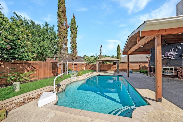 view of swimming pool with a patio area, a fenced backyard, a fenced in pool, and a gazebo