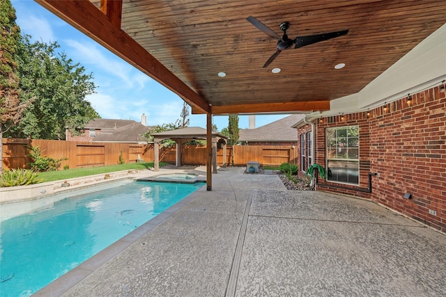 view of pool featuring a gazebo, a patio, a fenced backyard, and a ceiling fan