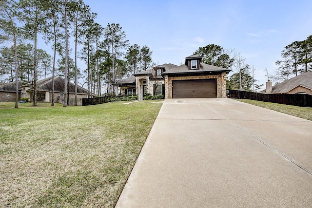 view of front facade with an attached garage, fence, driveway, stone siding, and a front lawn