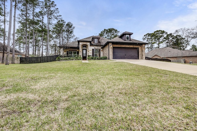 french provincial home with brick siding, an attached garage, a front yard, fence, and driveway