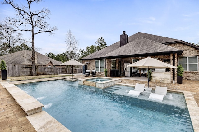 view of swimming pool with a pool with connected hot tub, a patio area, a fenced backyard, and a gazebo