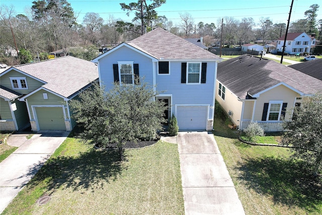 traditional home featuring concrete driveway, a residential view, roof with shingles, an attached garage, and a front lawn