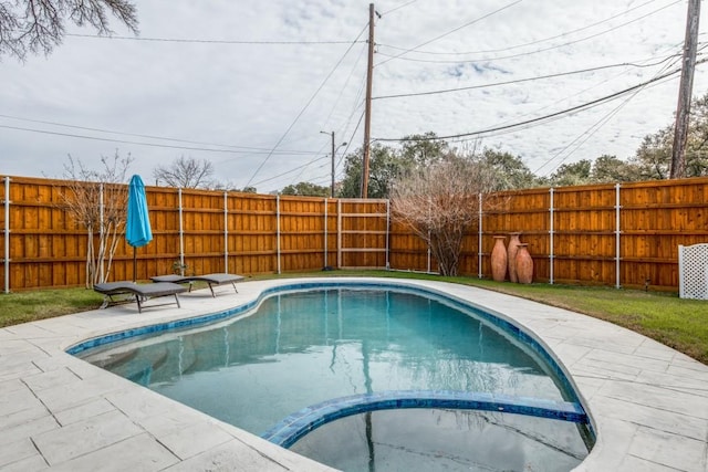 view of swimming pool with a pool with connected hot tub, a fenced backyard, and a patio