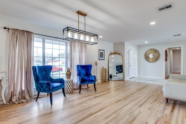 living area featuring recessed lighting, visible vents, and light wood finished floors