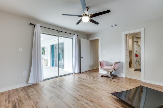 unfurnished room featuring baseboards, light wood-style flooring, visible vents, and a ceiling fan