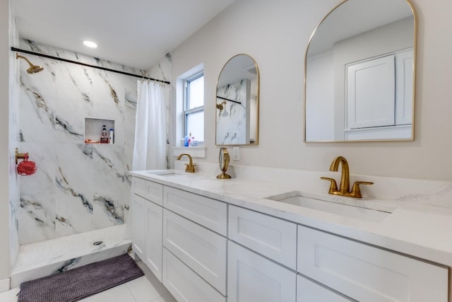 bathroom featuring double vanity, a marble finish shower, a sink, and recessed lighting